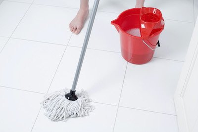 Person mopping tile floor