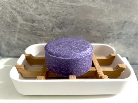 Shampoo bar on wooden soap dish tray