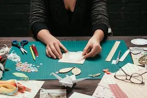 Woman using craft supplies to make homemade cards