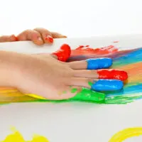 Young child painting with finger paint