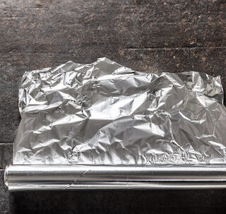 Aluminum foil on dark concrete background