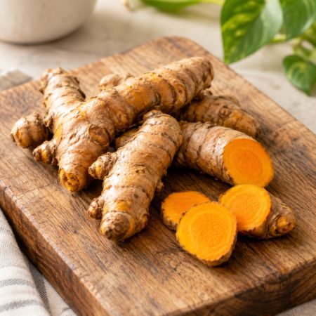 Turmeric roots on a wooden cutting board